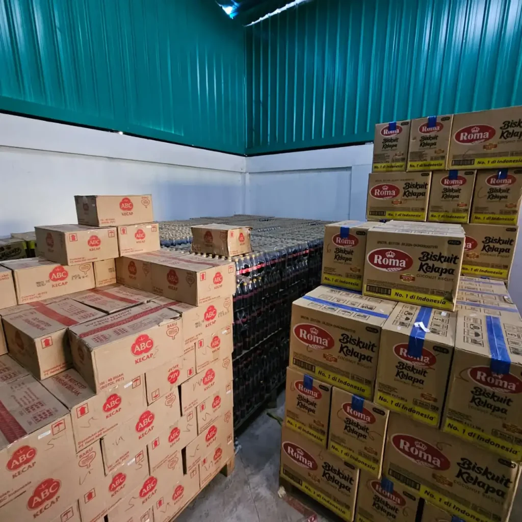 ABC and Roma products in warehouse storage with organized inventory of beverages & biscuits boxes by Sinarmas Marketing